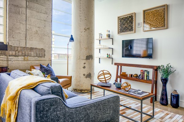Spacious living room with modern furnishings at Hecht Warehouse Apartments, luxury property by Greystar