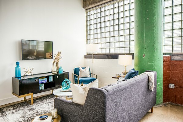Spacious living room with industrial design at Hecht Warehouse Apartments