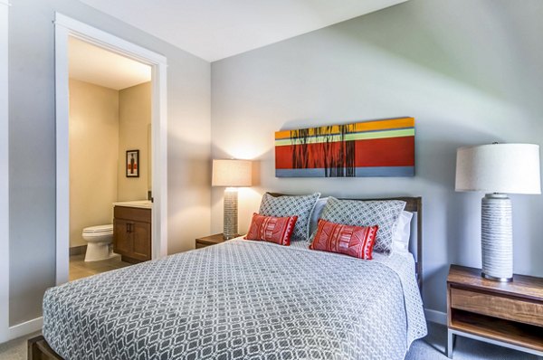 Cozy bedroom with natural light at Willow & Maple Apartments: luxury living by Greystar