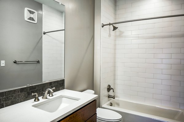 Modern bathroom with sleek fixtures at Willow & Maple Apartments, offering luxury living in a prime Greystar location