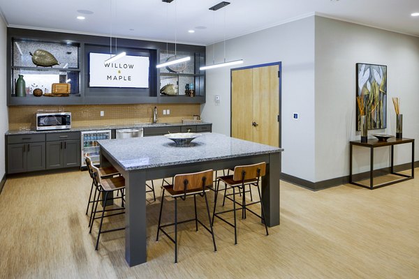 Clubhouse lobby with modern seating and elegant decor at Willow & Maple Apartments