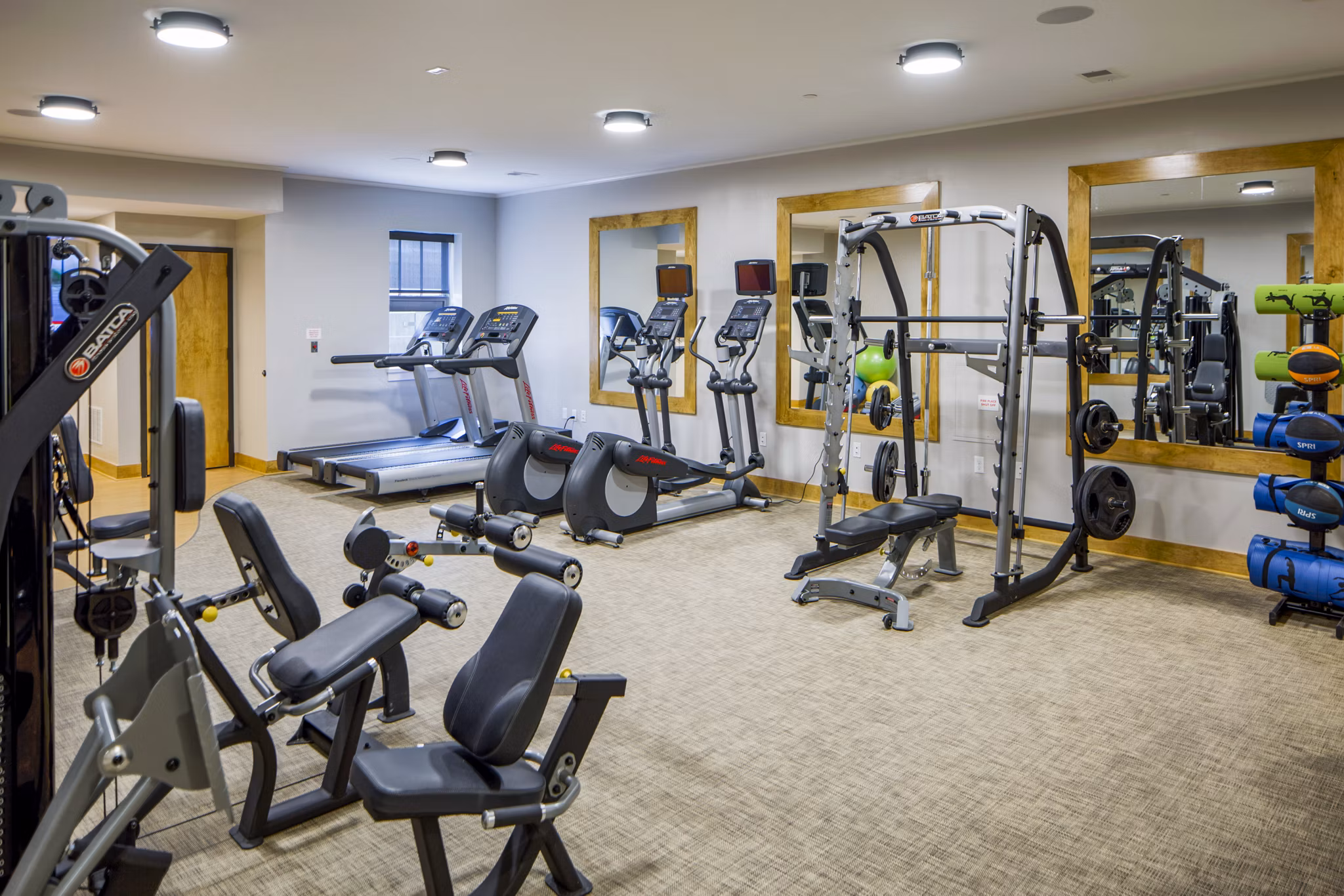 Modern fitness center with state-of-the-art equipment at Willow & Maple Apartments