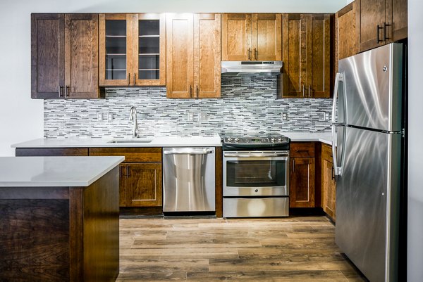 Modern kitchen with stainless steel appliances at Willow & Maple Apartments