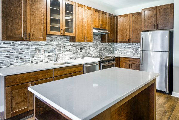 Sleek kitchen with stainless steel appliances at Willow & Maple Apartments