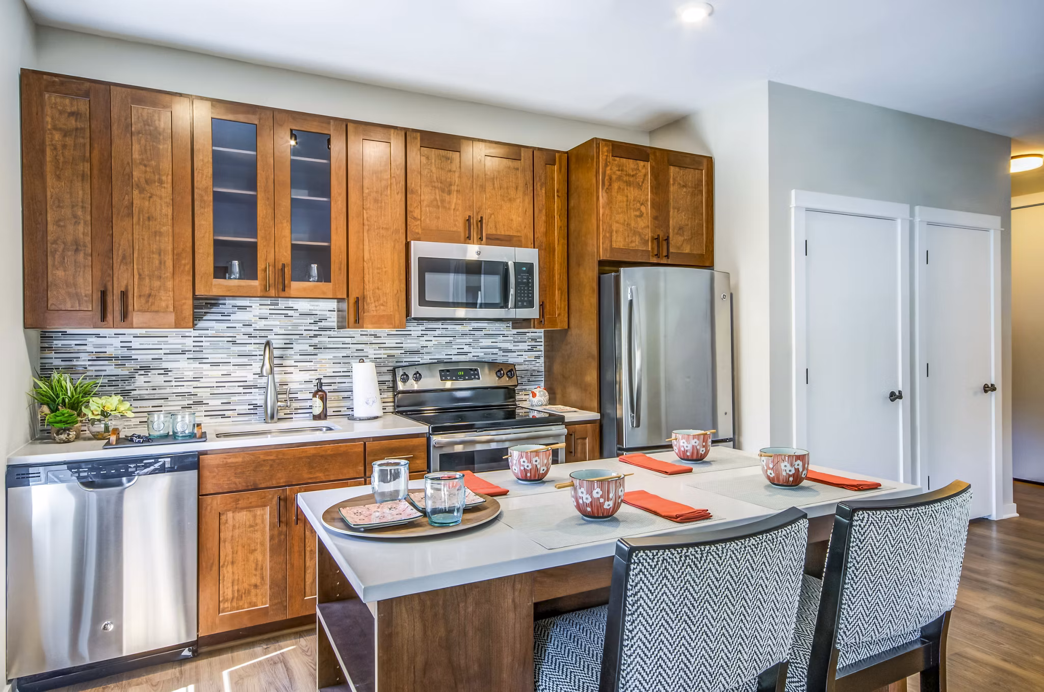 Modern kitchen with stainless steel appliances at Willow & Maple Apartments