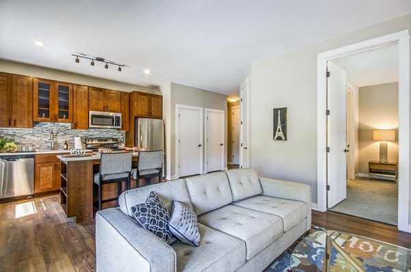 Stylish living room with modern decor and cozy seating at Willow & Maple Apartments