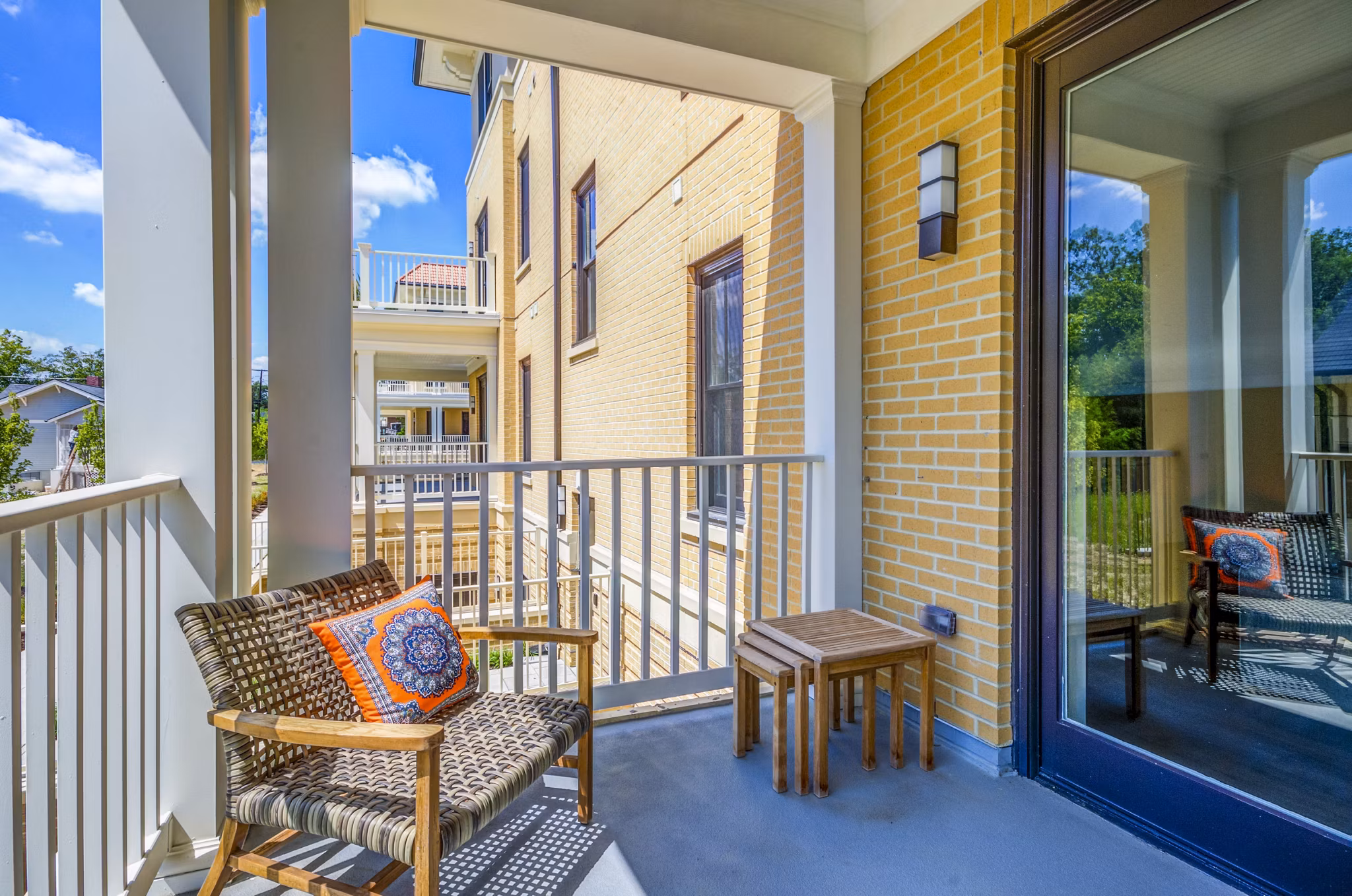 Private balcony overlooking greenery at Willow & Maple Apartments