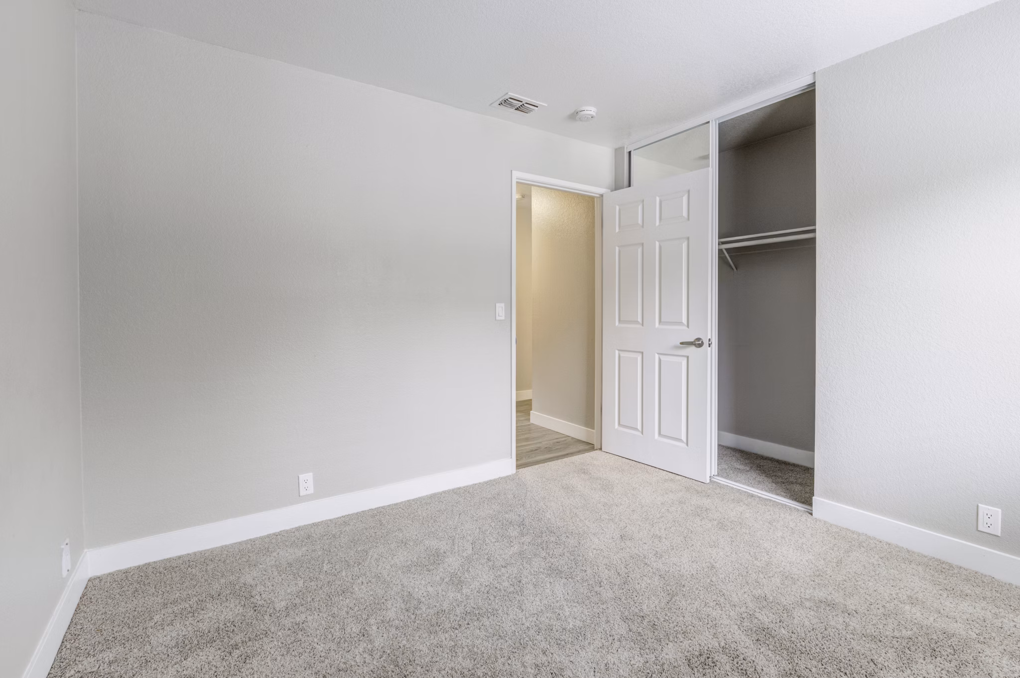 Bedroom with modern furniture and large windows at Avana Vista Point Apartments, offering comfort and style in a luxurious setting