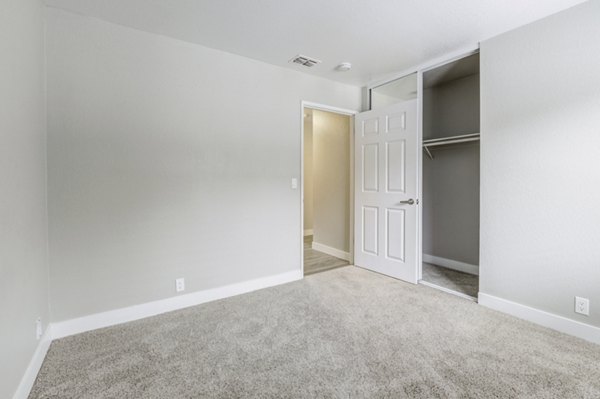 Bedroom with modern furniture and large windows at Avana Vista Point Apartments, offering comfort and style in a luxurious setting