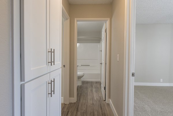Bright hallway adorned with modern lighting and art at Avana Vista Point Apartments