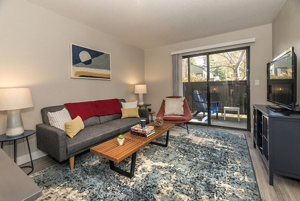 Living room with contemporary decor and large windows at Avana Vista Point Apartments luxury residences