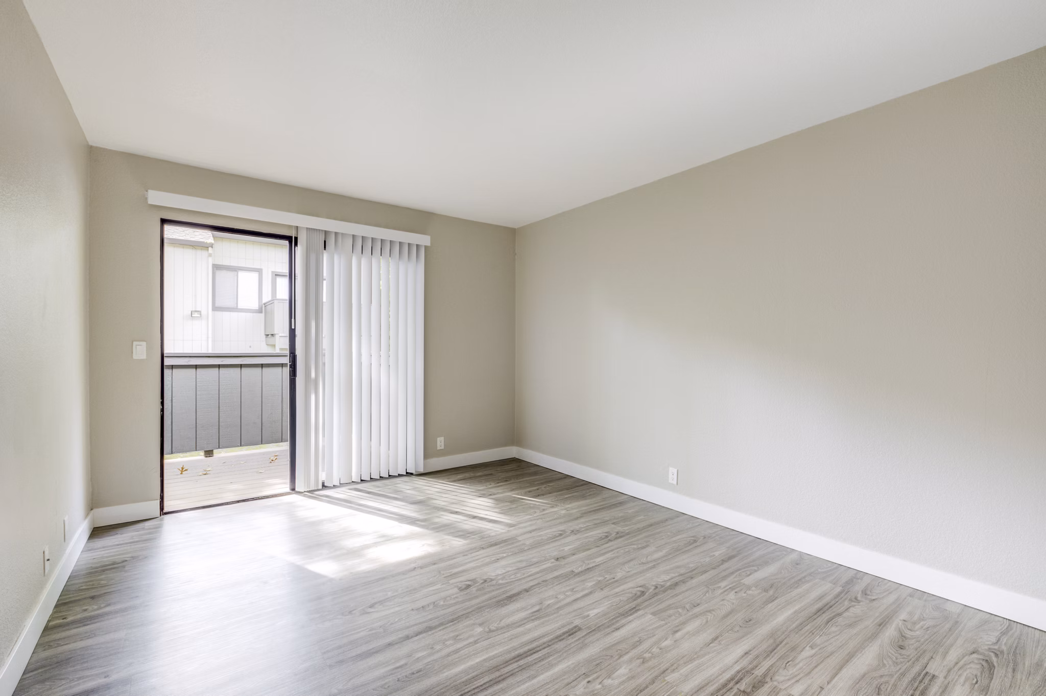 Spacious living room with modern decor and large windows in Avana Vista Point Apartments
