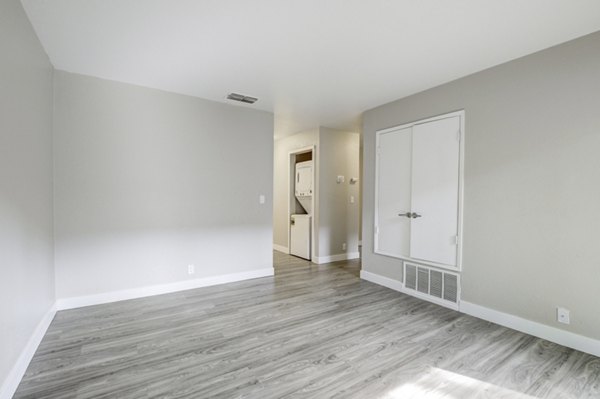 Spacious living room with modern decor and large windows in Avana Vista Point Apartments