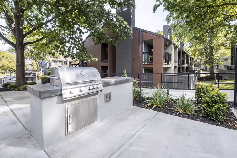 Outdoor grill area with modern seating at Avana Vista Point Luxury Apartments