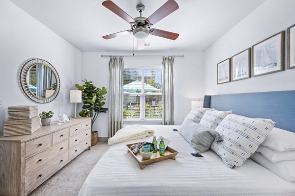 Bedroom featuring elegant decor and ample natural light at The Landing at Vinnin Square Apartments