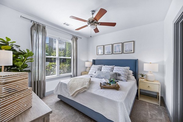 Bedroom featuring modern design and plush bedding at The Landing at Vinnin Square Apartments