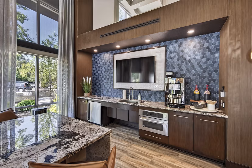 Modern clubhouse with stylish seating and game area at The Landing at Vinnin Square Apartments