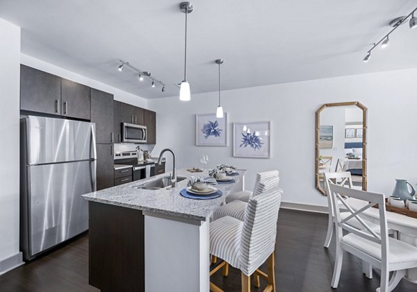 Dining area with modern furnishings and stylish lighting at The Landing at Vinnin Square Apartments Perfect for hosting gatherings and enjoying meals