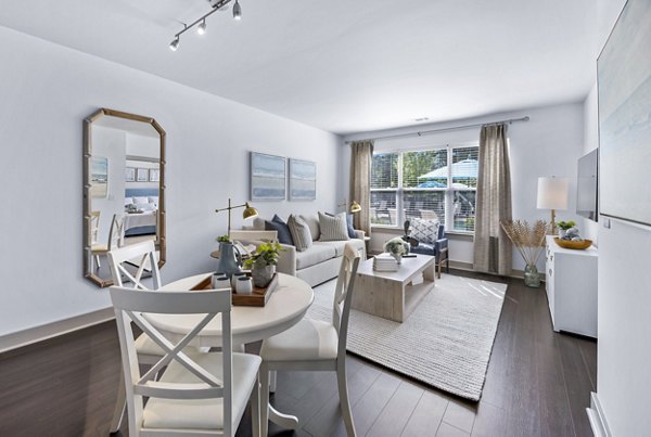 Dining room with elegant chandelier and modern decor in The Landing at Vinnin Square Apartments