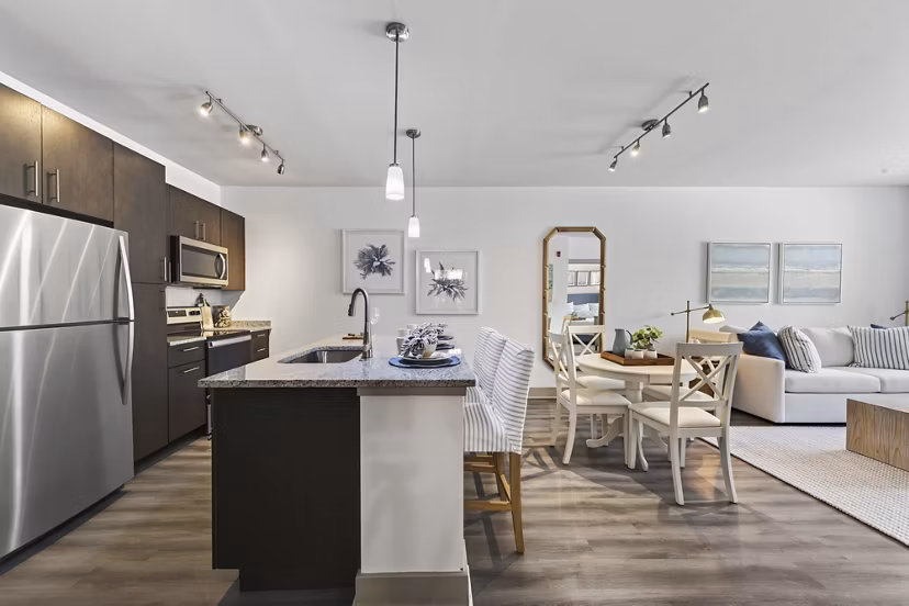 Modern kitchen featuring stainless steel appliances and granite countertops at The Landing at Vinnin Square Apartments