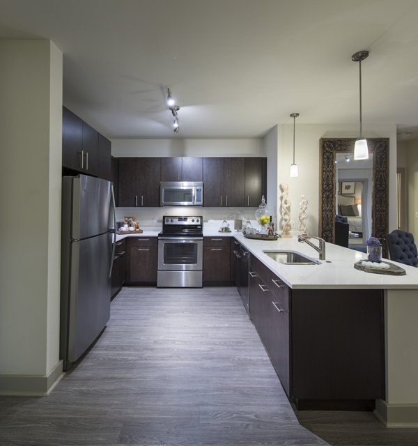 Modern kitchen featuring stainless steel appliances and granite countertops at The Landing at Vinnin Square Apartments