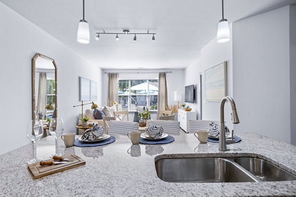 Kitchen with modern fixtures and stainless steel appliances at The Landing at Vinnin Square Apartments Ideal for Greystar luxury apartment living