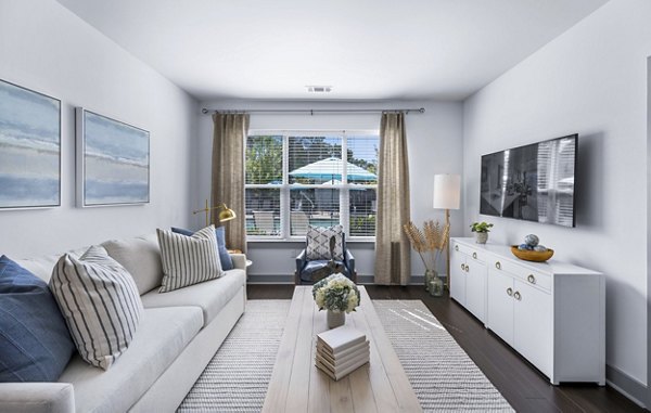 Spacious living room with modern decor in The Landing at Vinnin Square Apartments