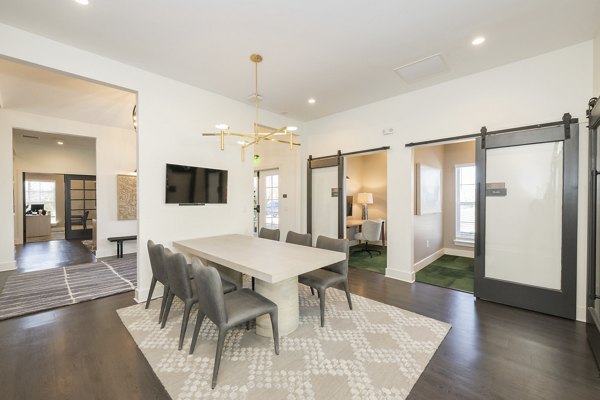 Spacious clubhouse with modern seating and entertainment area at Ryder Junction Apartments