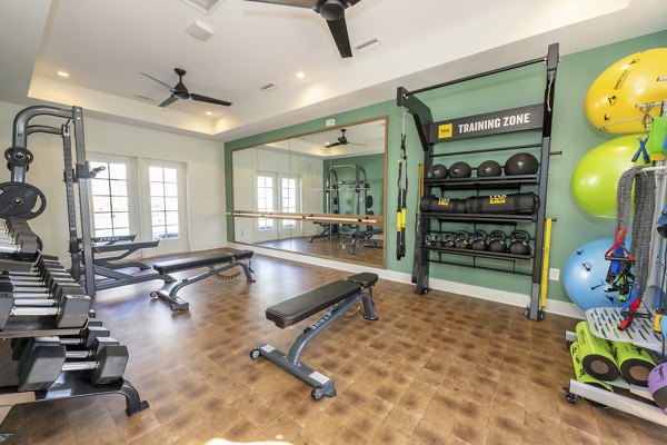State-of-the-art fitness center with modern equipment at Ryder Junction Apartments offering a luxurious workout experience