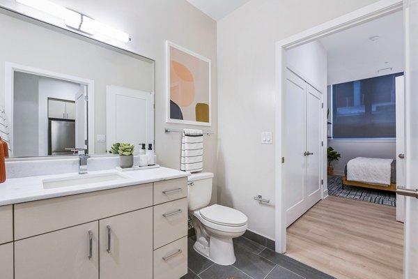 Modern bathroom featuring sleek fixtures at SoNYa Apartments, luxury living in urban setting