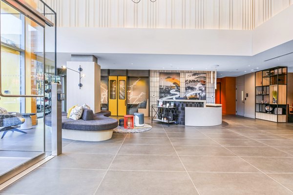 Clubhouse lobby with modern decor and seating area at SoNYa Apartments