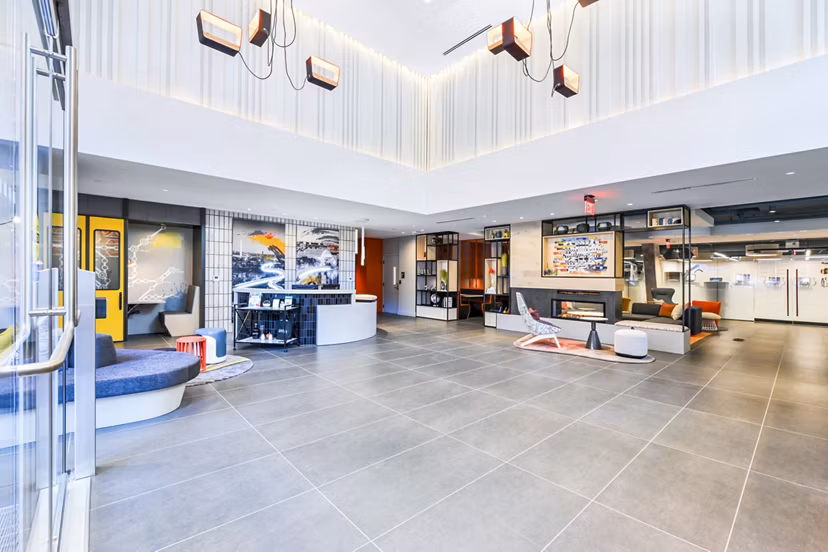 Clubhouse lobby featuring modern design and comfortable seating at SoNYa Apartments