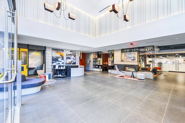 Clubhouse lobby featuring modern design and comfortable seating at SoNYa Apartments