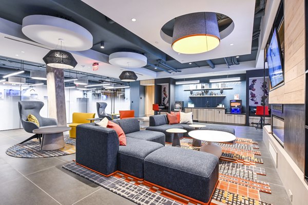 Modern clubhouse featuring stylish seating and entertainment areas at SoNYa Apartments