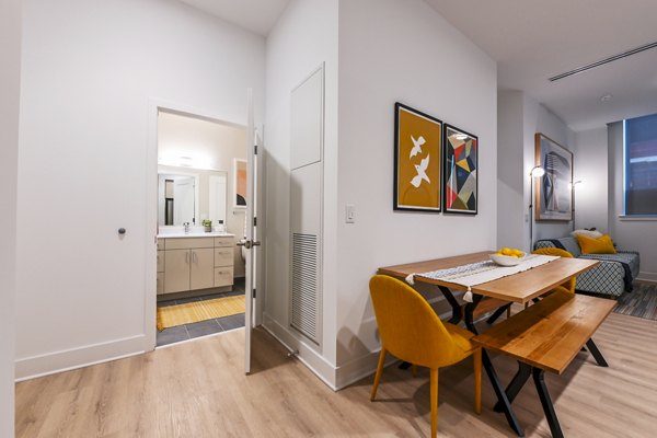 Dining room featuring modern decor and chic lighting in SoNYa Apartments, luxury living in the heart of the city