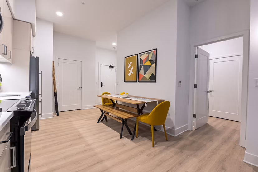 Dining room with modern decor and natural lighting in SoNYa Apartments