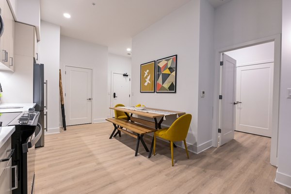 Dining room with modern decor and natural lighting in SoNYa Apartments