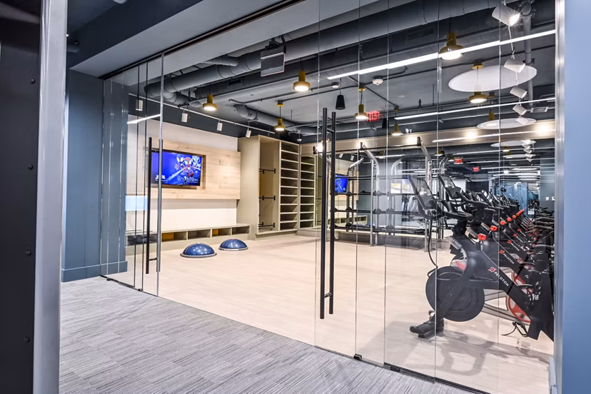 Bright yoga/spin studio equipped with bikes and mats at SoNYa Apartments