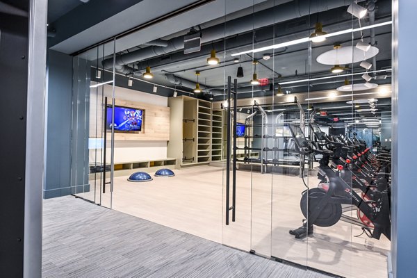 Bright yoga/spin studio equipped with bikes and mats at SoNYa Apartments