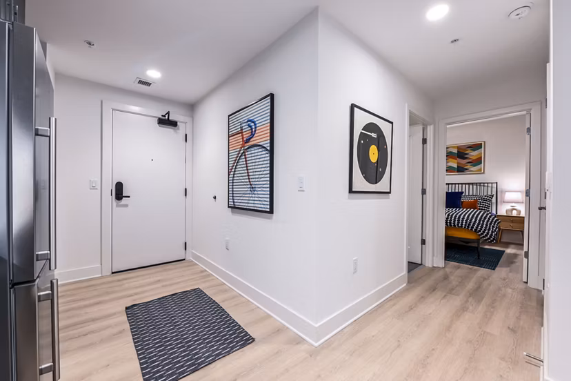 Contemporary kitchen with sleek countertops and modern appliances in SoNYa Apartments