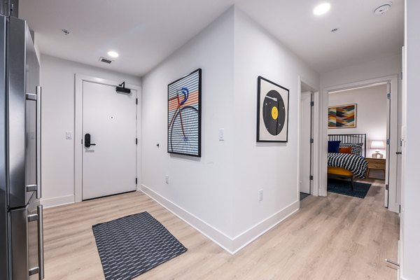 Contemporary kitchen with sleek countertops and modern appliances in SoNYa Apartments