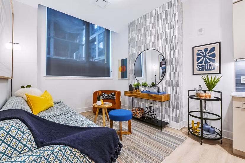Spacious living room with modern decor and abundant natural light at SoNYa Apartments