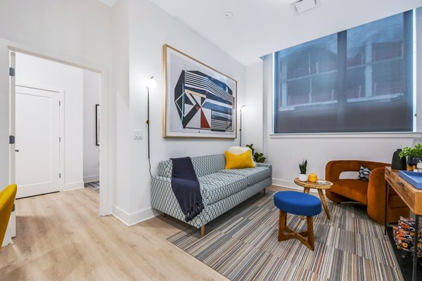 Contemporary living room with sleek design and ample natural light at SoNYa Apartments