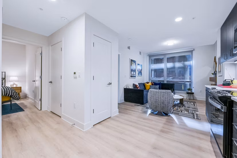 Modern living room featuring stylish furnishings and large windows at SoNYa Apartments