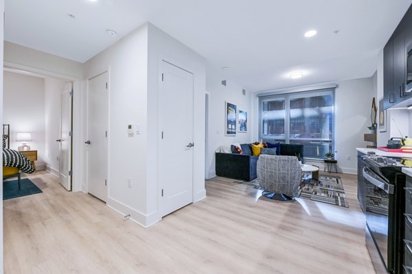 Modern living room featuring stylish furnishings and large windows at SoNYa Apartments