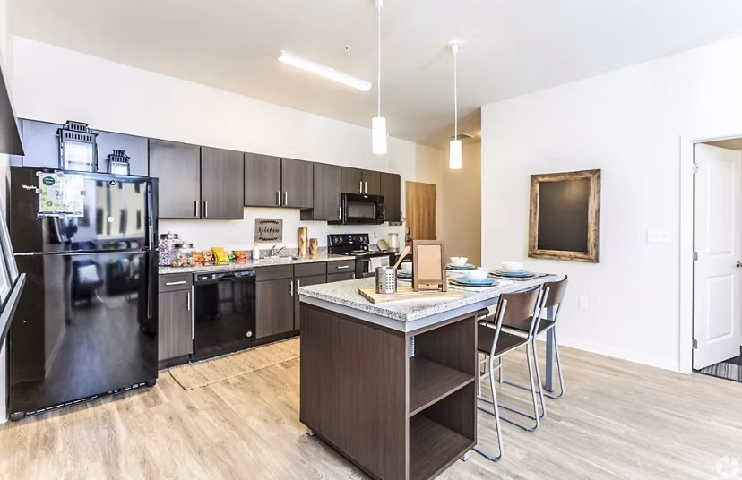 Modern kitchen with stainless steel appliances at The Edge Apartments