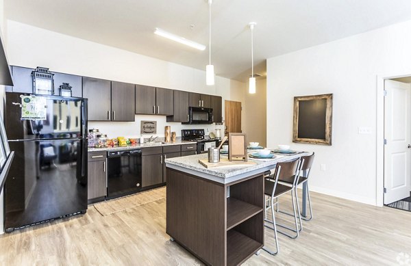 Modern kitchen with stainless steel appliances at The Edge Apartments