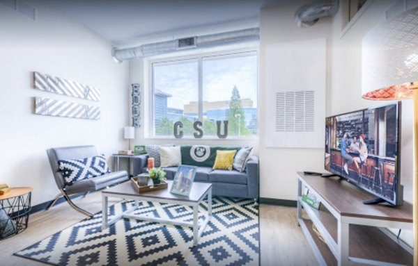 Spacious living room with modern decor at The Edge Apartments