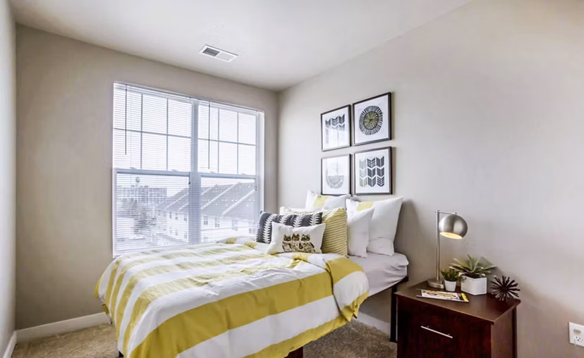 Cozy bedroom with modern furnishings at The Langston Apartments
