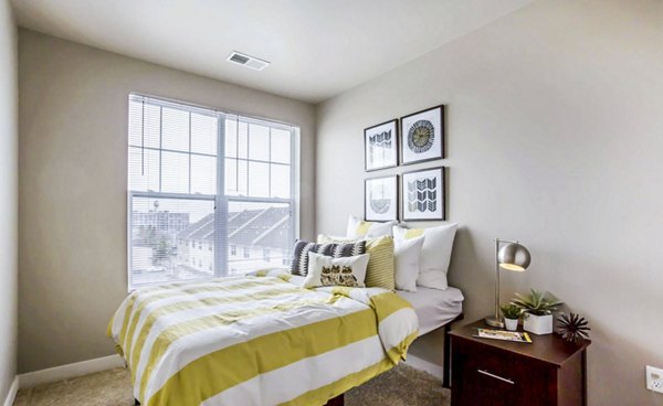 Cozy bedroom with modern furnishings at The Langston Apartments